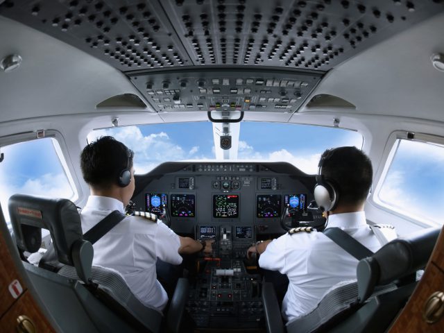 26391543 - pilot and co-pilot in private jet cockpit